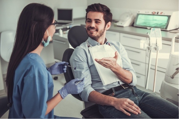 Dentist talking to dental patient