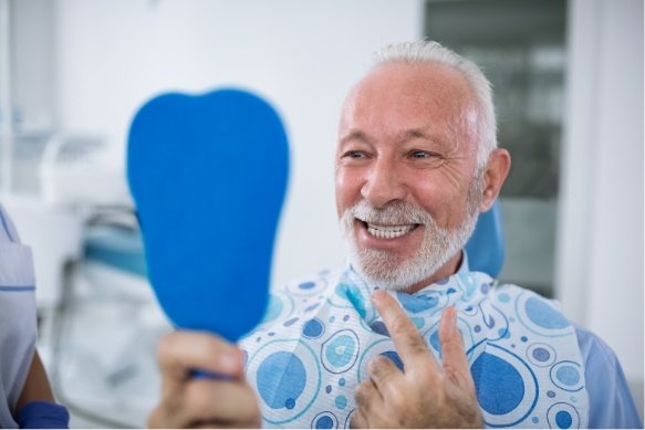 Man looking at flawless smile planed using virtual smile design