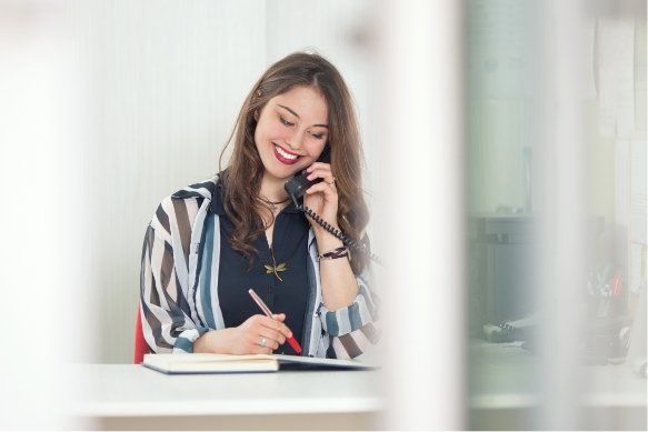 Smiling dental team member on phone