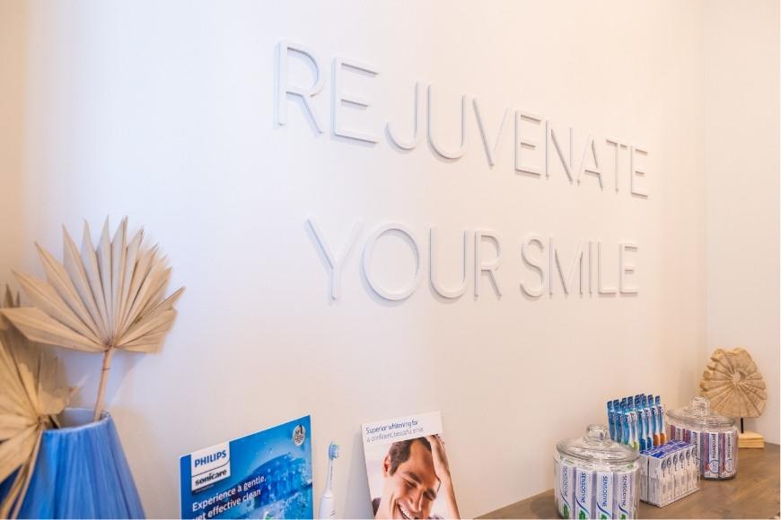 Closeup of rejuvenate your smile sign