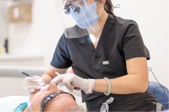 Dentist providing preventive dentistry checkup and teeth cleaning
