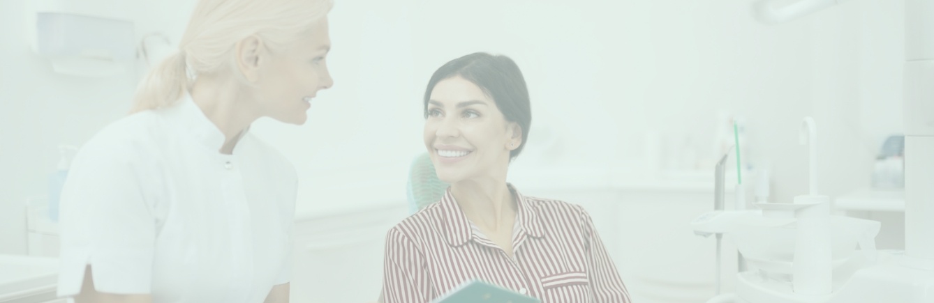 Dental team member discussing dental services with dentistry patient