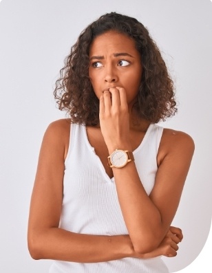 Woman covering smile before gum disease treatment