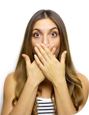 Woman covering her smile before replacing missing teeth