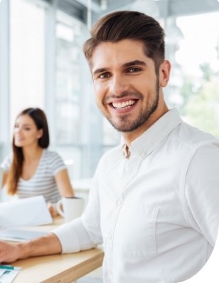 Young man with aligned smile thanks to orthodontics treatment